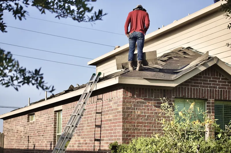 Professional roofer working on a residential roof in Tillman